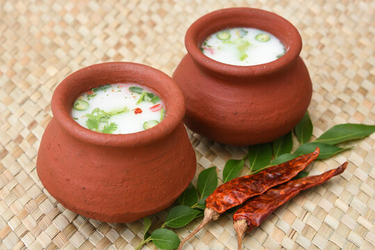 Spiced buttermilk / chaas / chaach / moru / sambharam / curd, lassi, yogurt, cool refreshing drink for hot summer in a clay pot, Kerala, India. Flavored Indian buttermilk.