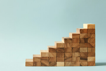 Stairs of wooden blocks on blue background.