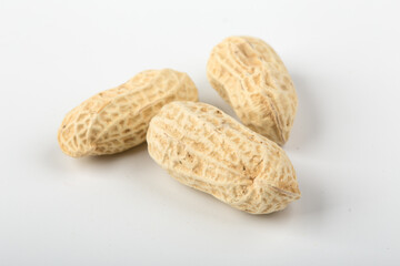 Unpeeled peanuts isolated on white