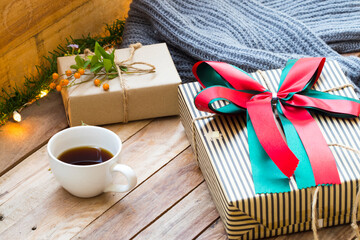 gift box for special day in festival day christmas and new year with hot coffee ,knitting wool scarf of lifestyle woman in winter season arrangement flat lay style on background wooden