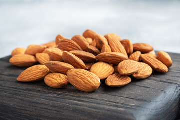 Peeled almonds on a wooden rustic background. Copy space.