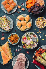 Baklava, halva, rahat lokum, sherbet, nuts, pistachios, dates, raisins, dried apricots, churchkhela. Assorted traditional eastern desserts, arabian sweets, turkish delight. Top view. Flat lay