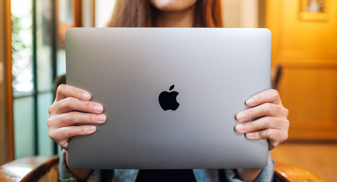 Sep 16th 2020 : A woman holding and showing an Apple MacBook Pro laptop computer , Chiang mai Thailand