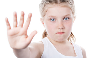 little girl showing hand stop sign