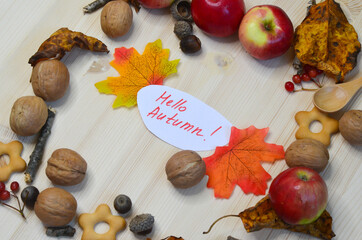 Autumn decor and decoration nuts leaves and apples on a wooden backgdrop. The concept of celebrating thanksgiving day
