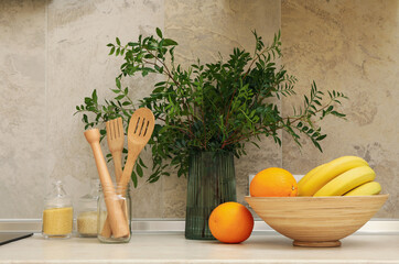 Naklejka na ściany i meble Kitchen interior with supplies, fruits and plant