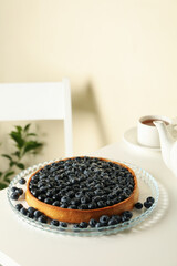 Concept of tasty breakfast with blueberry pie on white table