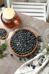 Concept of tasty lunch with blueberry pie on gray table