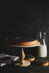Concept of tasty lunch with blueberry pie on wooden background