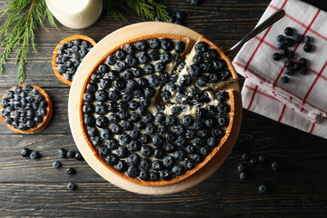 Concept of tasty lunch with blueberry pie on wooden background