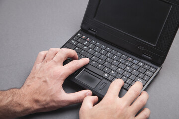 Male hands typing on computer keyboard.