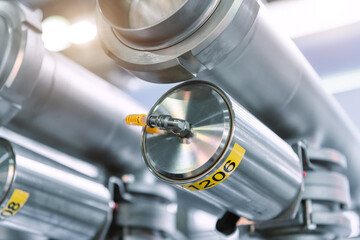 Large stainless pipes and steel cylinders.