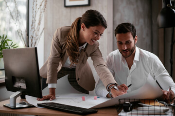 Businessman and businesswoman in office. Businesswoman and businessman working on the project..