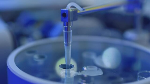 Apparatus for automatic sampling, analysis. A robo hand takes a sample from a test tube for testing or analysis. New technologies in science. Artificial intelligence is conducting an experiment.