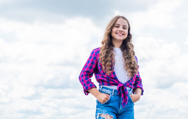 Child on the background of sky. summer holiday concept. childhood happiness. happy childrens day. free your imagination. kid beauty and fashion. child wearing casual style. copy space