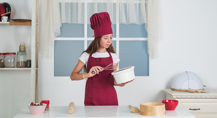 child beating with beater, kitchen utensil