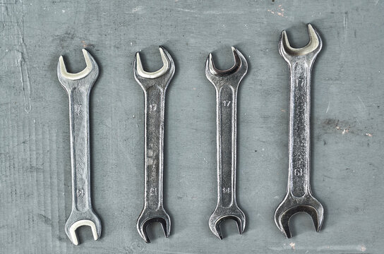 wrench on a gray painted wood surface. metal tools for manual work