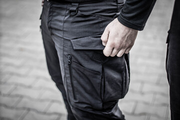 Man opens his pants pocket, man straightens his pants pocket, close-up, soft focus