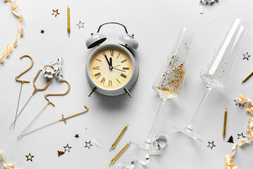 Beautiful New Year composition with alarm clock on light background