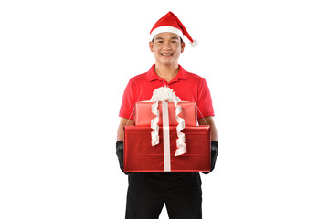 Happy young Asian delivery man in red uniform, Christmas hat carry boxes of presents in hands isolated on white background during Christmas festivities