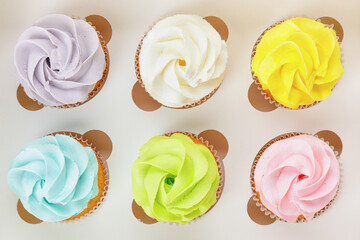 Box with tasty cupcakes, closeup