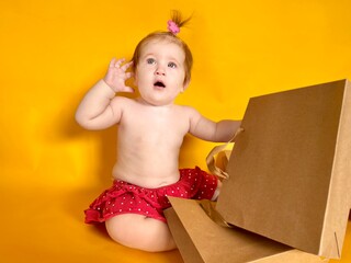 funny girl with packages on a yellow background