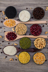 Cereal grains seeds beans on wooden background. Whole grains and bean. Cereals and beans. Different dry legumes for eating healthy