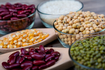 Soybean or soya bean in a bowl on wooden background. Soybeans with spoon and blow. Soybean organic background.