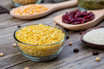 Organic split yellow mung beans in in blow. Split husked seeds of green gram, Mung dahl dried food ingredient. Traditional Indian deep fried.