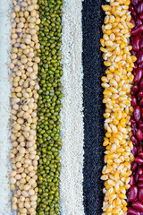 Cereal grains seeds beans on wooden background. Whole grains and bean. Cereals and beans. Different dry legumes for eating healthy