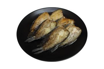fried fish without its head on circle black plate isolated on white