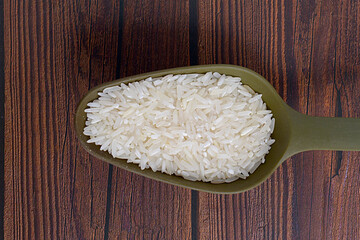 Uncooked rice in a spoon