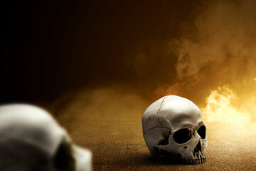 Human skull on the concrete floor with smoke