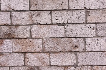 A grey bricked rectangular wall along with burn marks