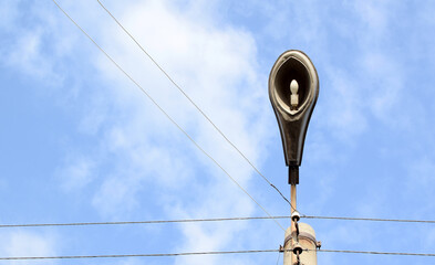 Old street lamp on blue sky background. Place for your text.