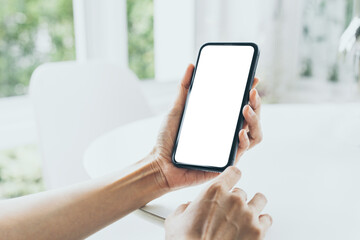cell phone mockup blank white screen.woman hand holding texting using mobile on desk at coffee shop.background empty space for advertise.work people contact marketing business,technology