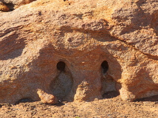 Water wash out looking like eyes at Chinaman Rock, Western Australia