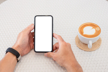 cell phone mockup blank white screen.man hand holding texting using mobile on desk at coffee shop.background empty space for advertise.work people contact marketing business,technology