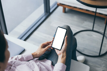 cell phone mockup blank white screen.woman hand holding texting using mobile on desk at coffee shop.background empty space for advertise.work people contact marketing business,technology