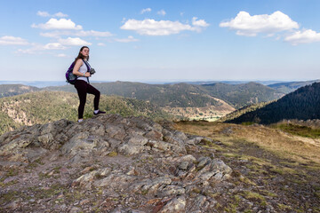 Obraz premium Fifteen year old girl standing on a rock in the Black Forest of Germany. 