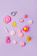 Abstract purple pastel background with kids accessories from clay, Concept of pop art culture, 80s, 90s, creative design, nen plastic bold color experimental idea