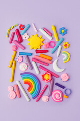 Abstract purple pastel background with many kids accessories from clay, wax chalk, Concept of pop art culture, 80s, 90s, creative design, nen plastic bold color experimental idea