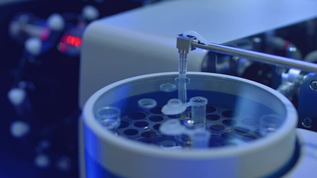 Apparatus for automatic sampling, analysis. A robo hand takes a sample from a test tube for testing or analysis. New technologies in science. Artificial intelligence is conducting an experiment.