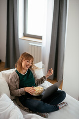 Young woman having video call. Beautiful woman enjoying at home..