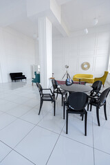 modern fashionable futuristic interior design of a spacious white hall with black and yellow furniture