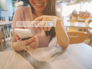 The girl smiles and uses a smartphone to find what you are interested. Searching information data...