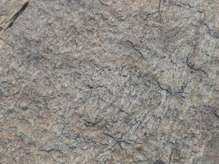 Natural background of rock in riverside india.  Stones texture and background. Rock texture. Rock fragment. Abstract background. A fragment of rock. 
