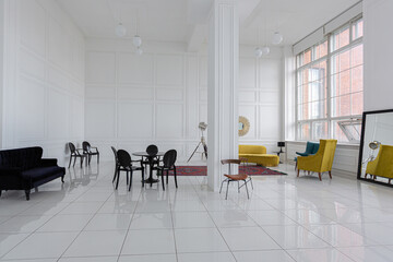 modern fashionable futuristic interior design of a spacious white hall with black and yellow furniture