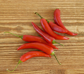 Red hot chillies on wooden background