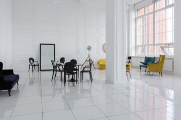 modern fashionable futuristic interior design of a spacious white hall with black and yellow furniture